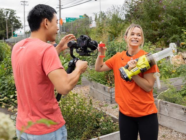 gardener showing filming crew tools